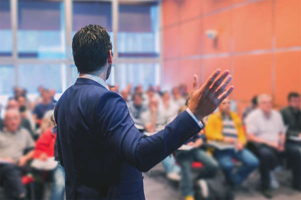 Man speaking before a group of people