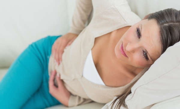 Woman with IBS clutching her stomach